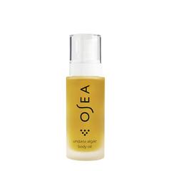 Clear bottle containing yellow liquid with a white pump, labeled as body oil.