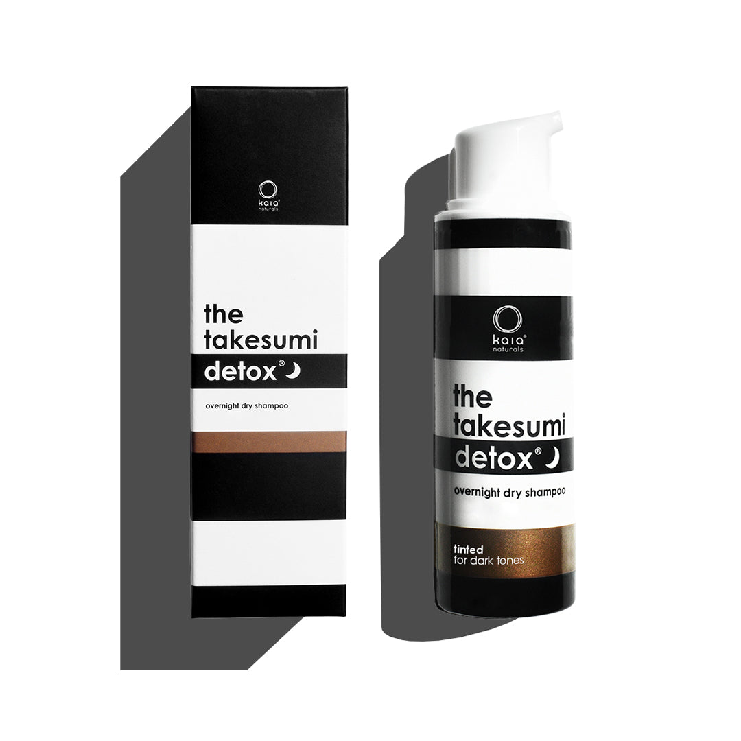 A product display of the takesumi detox overnight dry shampoo designed for dark tones.